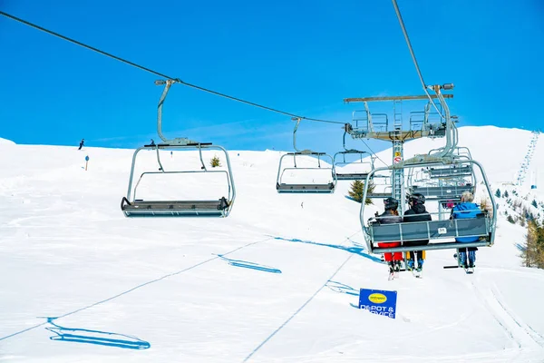 March 20, 2018. Austria. Ski lifts and cable cars going up the mountain bringing snowboarders to ski slopes. Ski resort.