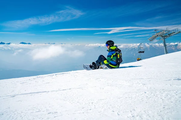 Joven Snowboarder Sentado Cima Montaña Admirando Vista Sobre Las Nubes —  Fotos de Stock
