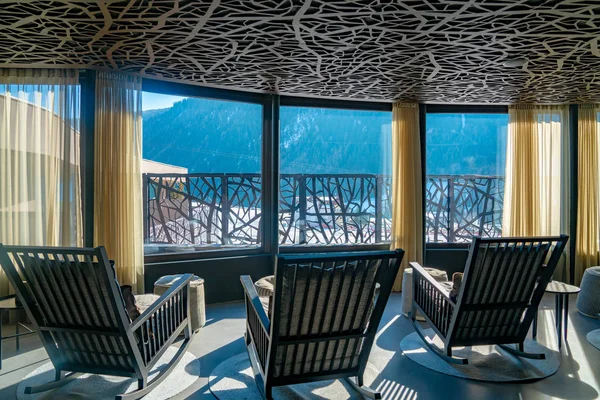 Alpina hotel, Saalbach. Austria. March 30, 2018. Amazing SPA terrace interior design with mountain view. Comfortable chairs and sofas. Ski resort luxury hotel SPA.