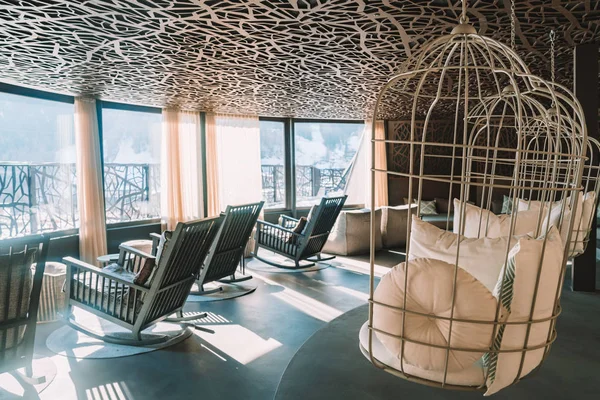 Alpina hotel, Saalbach. Austria. March 30, 2018. Amazing SPA terrace interior design with mountain view. Comfortable chairs and sofas. Ski resort luxury hotel SPA.