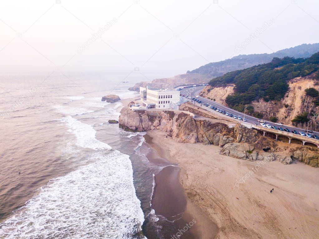 San Francisco Pacific ocean aerial beach with huge waves and coast going up to the horizon near the famous Cliff house restaurant.