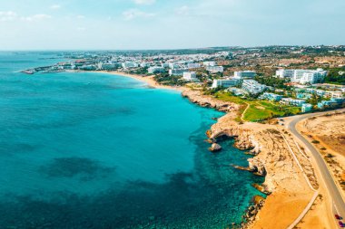 Ayia Napa 'daki Nissi plajı, Kıbrıs' taki ünlü turist plajının temiz hava fotoğrafı. Kıbrıs 'ın en iyi tatil yeri, Nissi plajı, oteller, körfezler, parklar