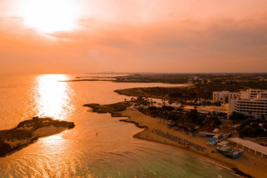 Ayia Napa 'daki Nissi plajı, Kıbrıs' taki ünlü turist plajının temiz hava fotoğrafı. Kıbrıs 'ın en iyi tatil yeri, Nissi plajı, oteller, körfezler, parklar. 