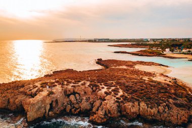 Ayia Napa 'daki Nissi plajı, Kıbrıs' taki ünlü turist plajının temiz hava fotoğrafı. Kıbrıs 'ın en iyi tatil yeri, Nissi plajı, oteller, körfezler, parklar.