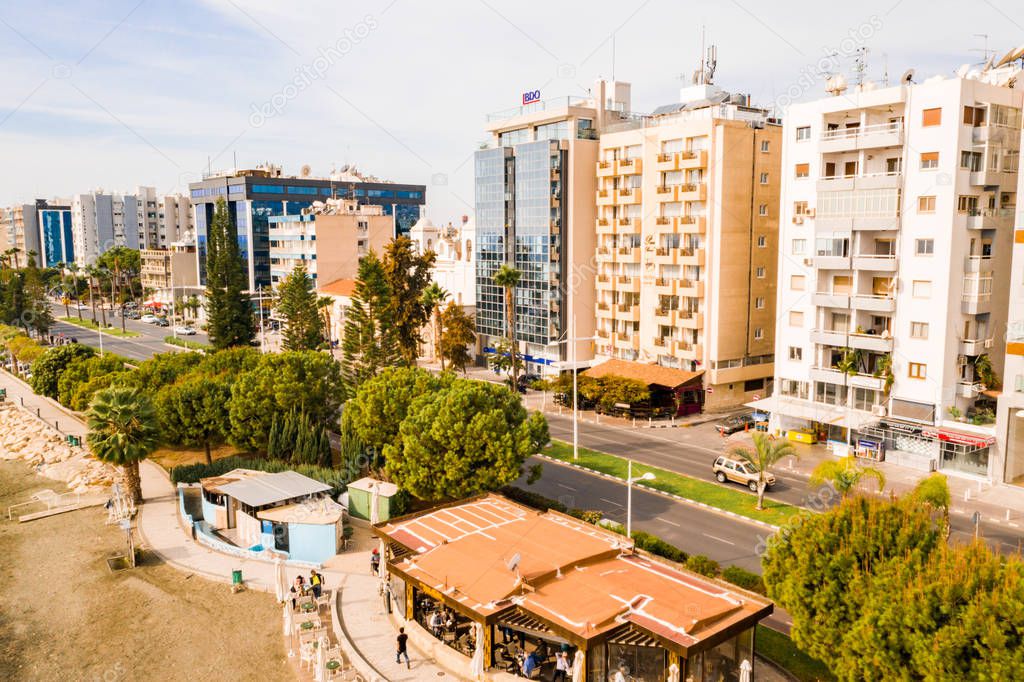 November 10, 2018, Limassol, Cyprus. Aerial view of Molos Promenade park on coast of Limassol city centre,Cyprus. Bird's eye view of the beachfront walk path and palm trees, Mediterranean sea