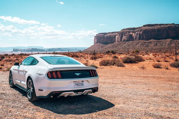 stock image Monument Valley, USA. July 10, 2018. White Ford Mustang GT parked by the side of the road in the heart of the Monument Valley park.