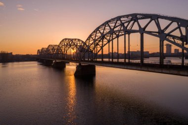 Mor turuncu gün batımı sırasında Riga, Letonya çarpıcı havadan görünümü. Eski şehir, asma köprü ve Nehir Daugava görünümü.