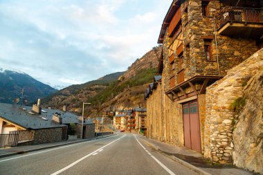 Beautiful winter road through Andorra mountains and small villages clipart