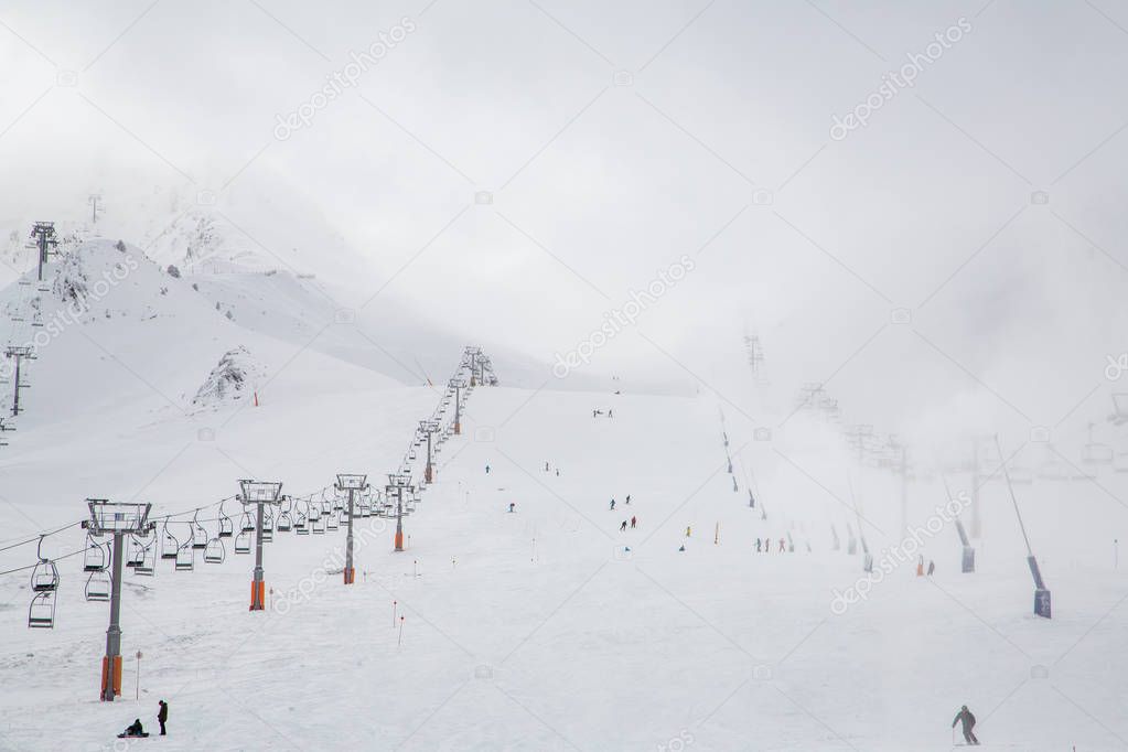Ski slopes in Andorra with people skiing in the mountains.