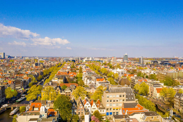 Beautiful aerial Amsterdam view from above with many narrow canals, streets and architectures.