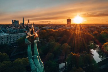 Central Park ve özgürlük heykeli yakınındaki Riga üzerinde gün batımı görünümü.  