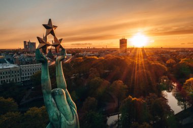 Central Park ve özgürlük heykeli yakınındaki Riga üzerinde gün batımı görünümü.  