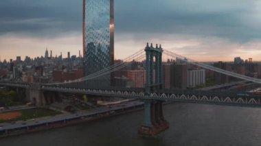 Manhattan Köprüsü yapısı ve New York şehir güneşin doğuşunda havadan görünümü.