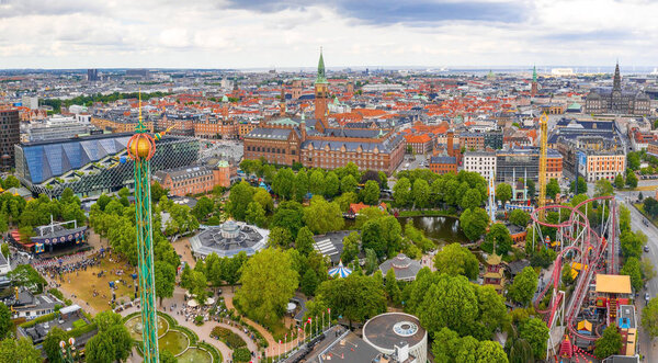 COPENHAGEN, DENMARK - JUNE 2019 - Aerial view of the Tivoli Gardens amusement park with people, visitors, attractions and rides. Urban view of the city of Copenhagen in Denmark, Europe