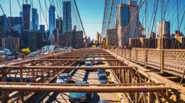 Beautiful time lapse view of the Brooklyn Bridge in motion. Cars and people passing the bridge from Manhattan island to Brooklyn.