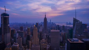 New York City skyline with urban skyscrapers at sunset. Time lapse, the flow of time.