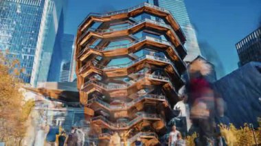 New York, USA - May 9, 2019: Vessel (architect Thomas Heatherwick), Hudson Yards Staircase, at the Hudson Yards district in Manhattan on sunny summer day. Focus on Vessel. Time lapse view.