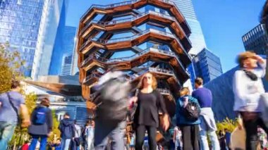 New York, USA - May 9, 2019: Vessel (architect Thomas Heatherwick), Hudson Yards Staircase, at the Hudson Yards district in Manhattan on sunny summer day. Focus on Vessel. Time lapse view.