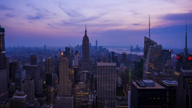 New York City skyline with urban skyscrapers at sunset. Time lapse, the flow of time.