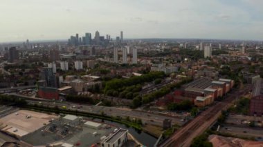 Flying over London with a beautiful city of London district and Canary Wharf view on the horizon.