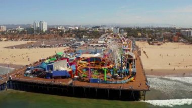 Aerial view of the Santa Monica Pier, in Santa Monica, LA, California. Beautiful view of the pier with amusement park and people around it.
