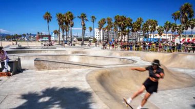 Beautiful aerial view of the skate park at the Venice beach in LA, California near the Pacific ocean. People skating down the skate park by the beach. Most popular skate park in the world.