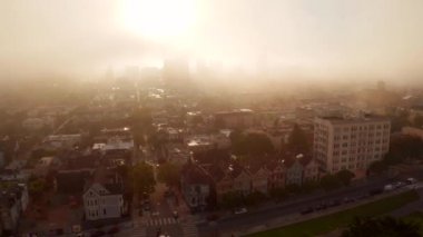 Aerial shot of the world famous Painted Ladies located in Alamo Square, San Francisco during beautiful cloudy morning with an epic sunrise.