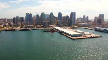 Aerial view of the San Diego harbour near the Downtown, CA. Flying near the docks and USS Midway carrier.