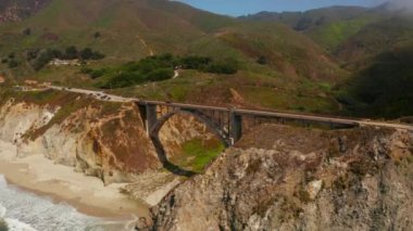 Scenic panoramic time lapse view of clouds passing historic Bixby Creek Bridge along world famous Highway 1 during summer, Monterey County, California, USA