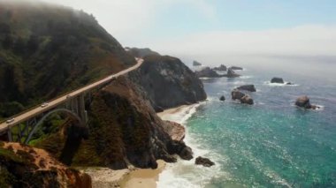 Scenic panoramic time lapse view of clouds passing historic Bixby Creek Bridge along world famous Highway 1 during summer, Monterey County, California, USA