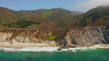 Scenic panoramic time lapse view of clouds passing historic Bixby Creek Bridge along world famous Highway 1 during summer, Monterey County, California, USA