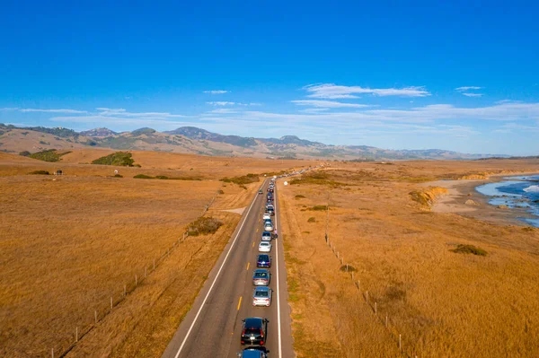 California Highway Traffic. Trucks and cars on the Highway 1 are stuck because of the accident. Huge truck blocked the road both ways. American transportation theme.