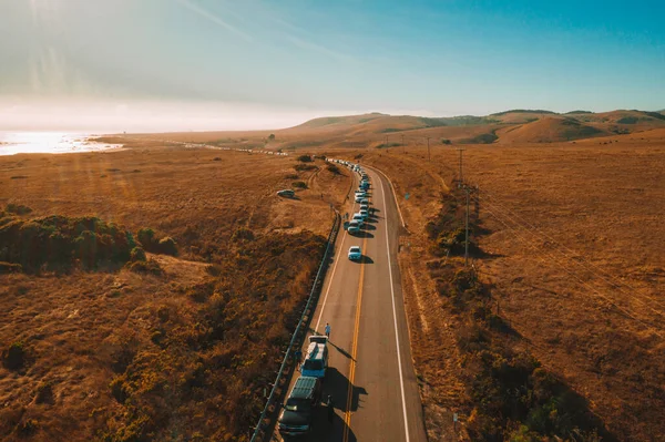 California Highway Traffic. Trucks and cars on the Highway 1 are stuck because of the accident. Huge truck blocked the road both ways. American transportation theme.