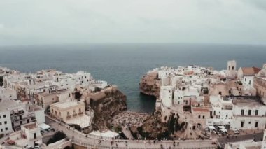 Polignano a Mare kasabası, Puglia bölgesi, İtalya ve Avrupa 'nın ilkbahar panoramik manzarası. Adriyatik denizinin muhteşem manzarası. Seyahat konsepti geçmişi. Turkuaz deniz suyu.