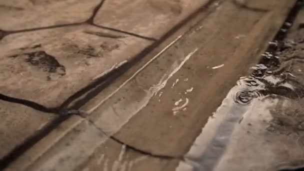 Rain pours in the summer on a beautiful paving stone in a country house — Stock Video