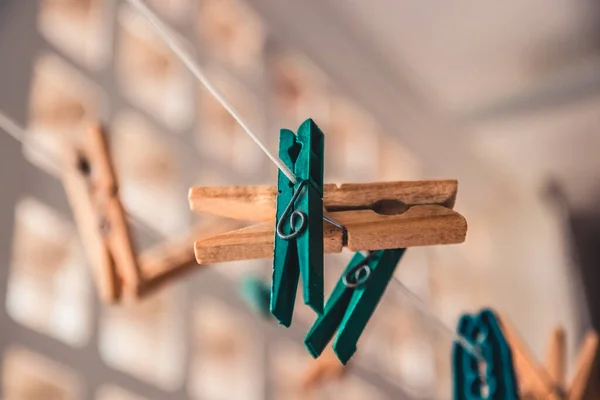 Clothespins holding clothes in laundry. clothes-peg on a string