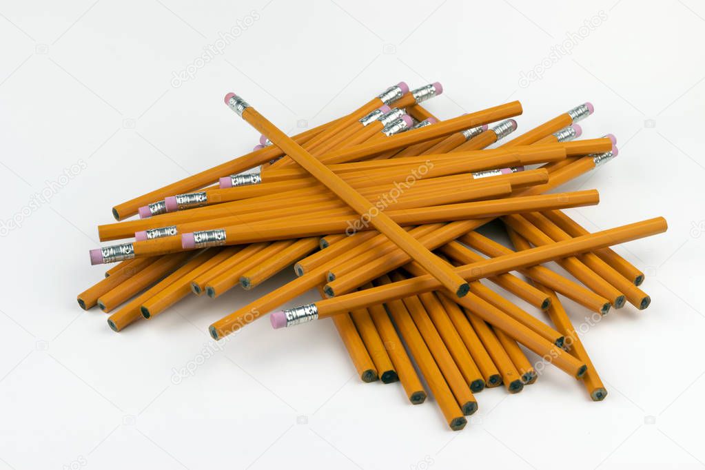 A jumbled, disorganized stack of unsharpened, orange, six-sided pencils ready to be sharpened for writing at school or in an office.