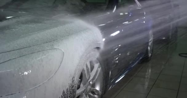 Car wash using a white foam detergent cleanser in slow motion — Stock Video