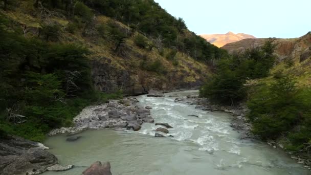 Majestic Aerial drone flight through epic landscape mountain river between rocks. Torres del Paine National Park, Chilean Patagonia — Stock Video