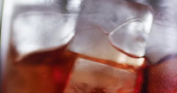 冰块与饮料混合在玻璃杯中。调酒师使用长金属勺子。6k 红色摄像机的特写镜头. — 图库视频影像