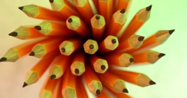 Yellow coated pencils rotating in slow motion. Close up top view, shot on RED 6K camera — 비디오