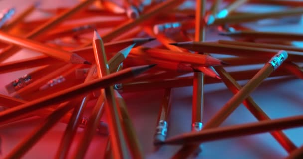 Yellow coated pencils rotating in slow motion. Close up view, shot on RED 6K camera — Stock Video