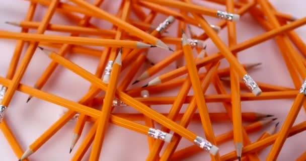 Yellow coated pencils rotating in slow motion. Close up view, shot on RED 6K camera — Stock Video