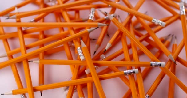 Yellow coated pencils rotating in slow motion. Close up view, shot on RED 6K camera — Stock Video