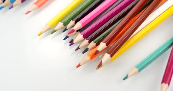 Des crayons de couleur apparaissent sur fond blanc. Vue rapprochée, prise de vue sur caméra RED 6K 