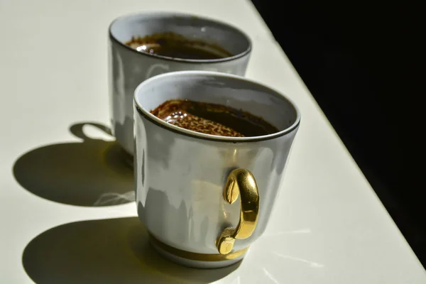 black coffee in a coffee cup top view isolated on white background.