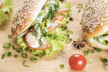 hızlı abur cubur lezzetli sosisli sandviç küçük kiraz domates yakın masada sulu yeşil ve Barbekü soslu