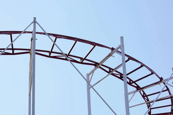 Rollercoaster contro il cielo blu la sera — Foto Stock