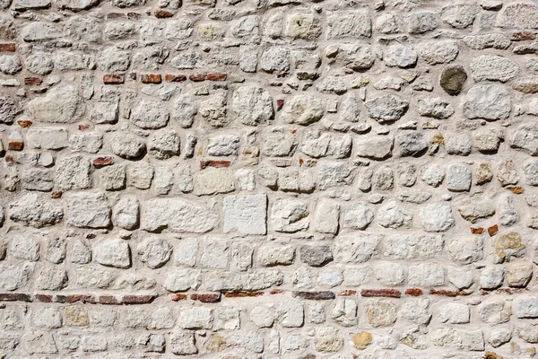 Stonewall sfondo intemperie da un muro del castello — Foto Stock