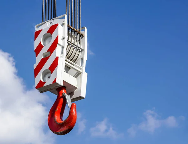 Gancio gru con strisce bianche e rosse appese, cielo blu sullo sfondo — Foto Stock